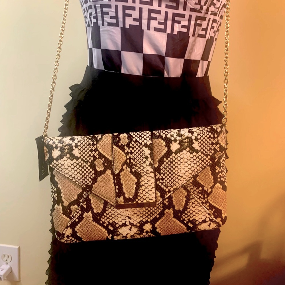 Peach Faux Snake Skin crossbody bag with gold accent chain.